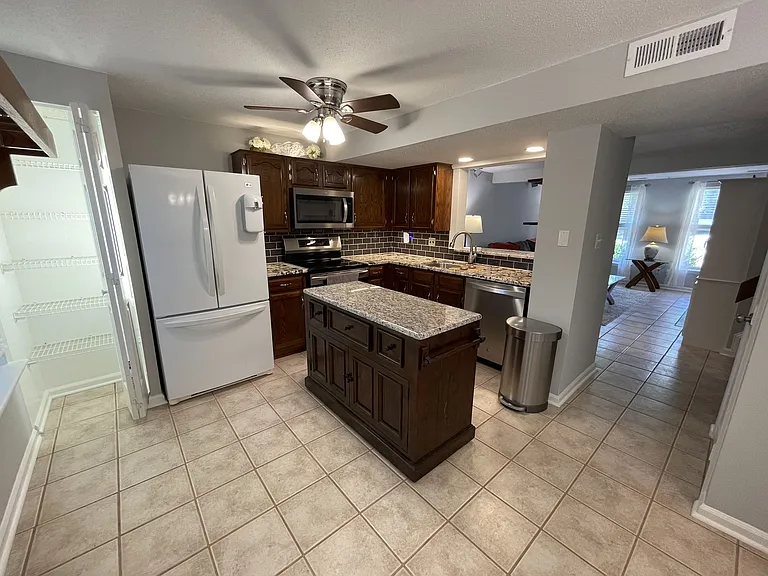 Kitchen with movable center island - move over when cooking and need the counter space, move out of the way when you need the walking space