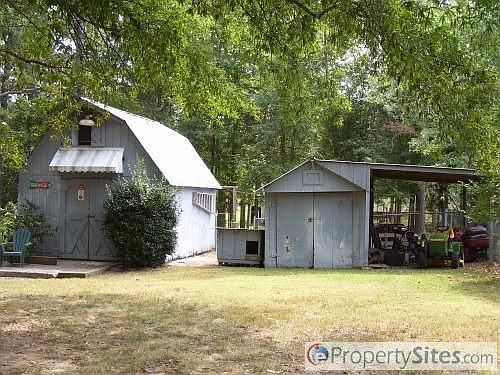 Lots of storage, fenced 1/2 acre lot