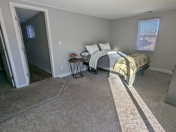 Master bedroom with access to yard surrounded by privacy fence