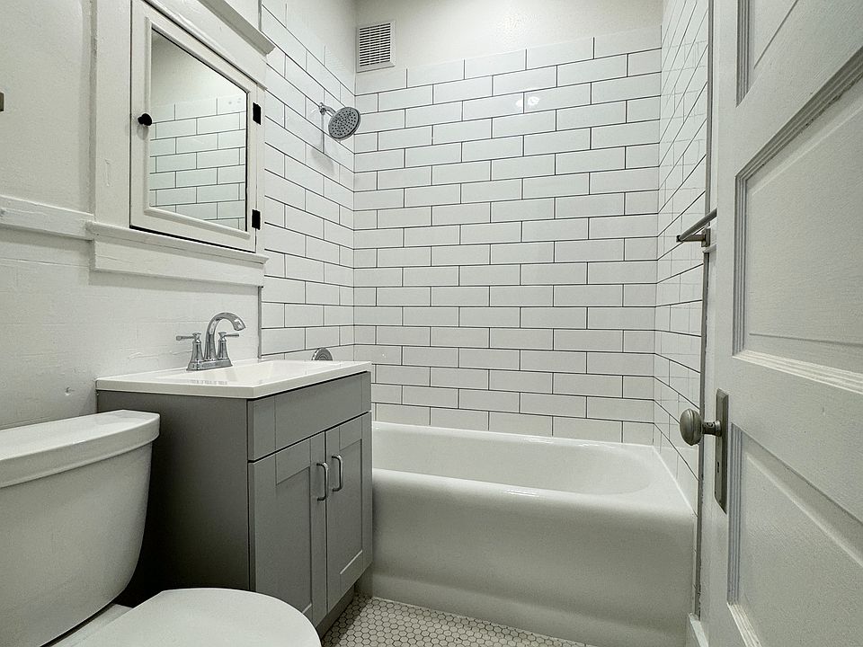 Completely modernized bathroom with new subway tile shower surround, vanity and toilet