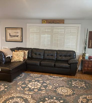 Large couch in the family room with shutters that allow for lots of light!