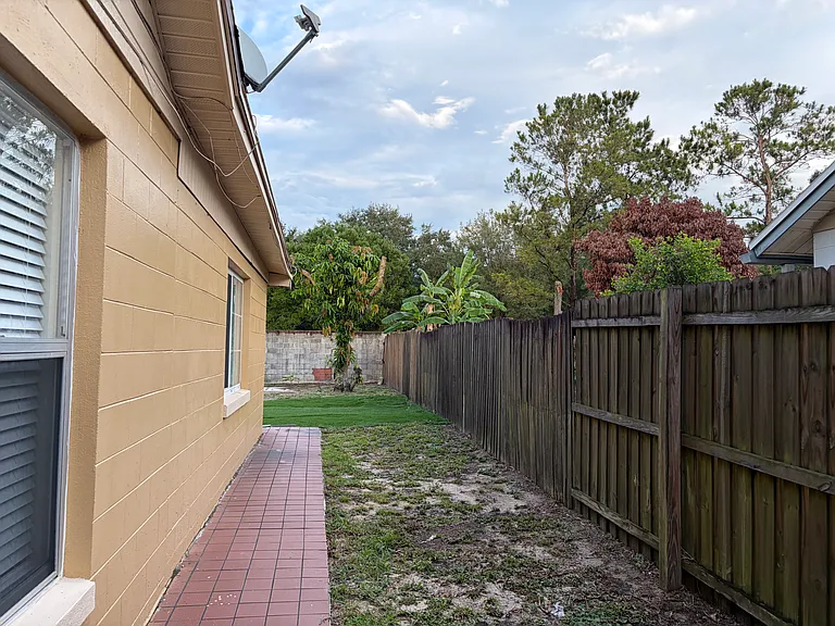 Side of the house from the fenced in backyard