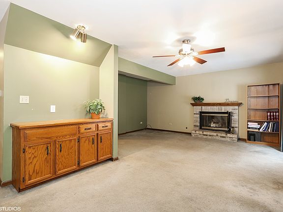 Huge living room with fireplace and sliding patio doors to fenced back yard