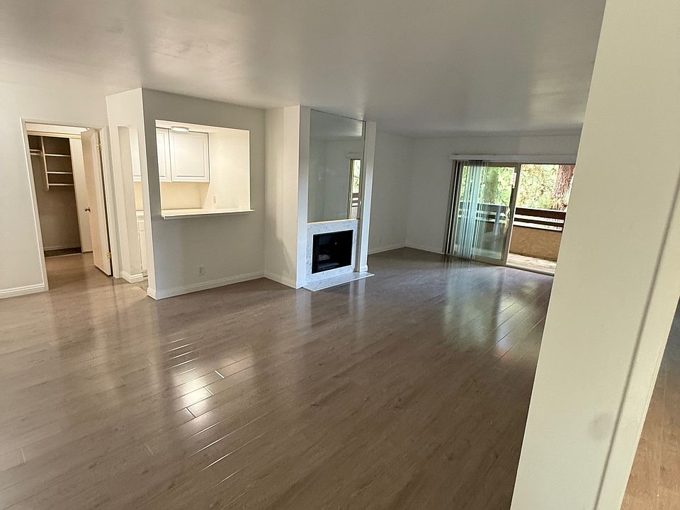 living room showing fire place and sliding glass doors to outside sitting area.