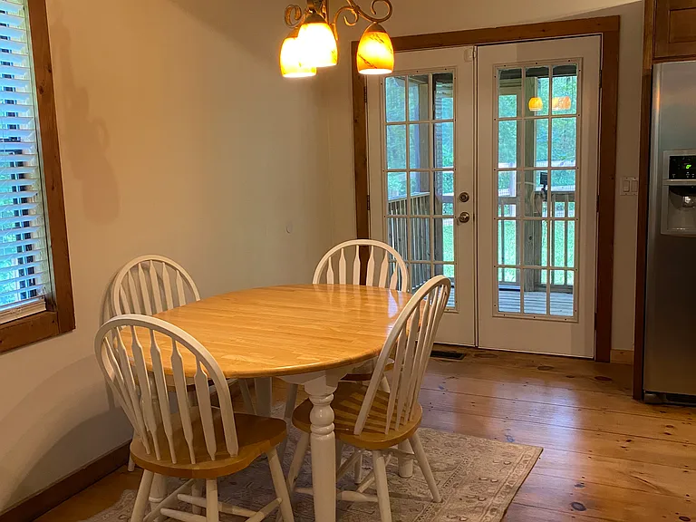 Dining table view leads to screened in back porch.