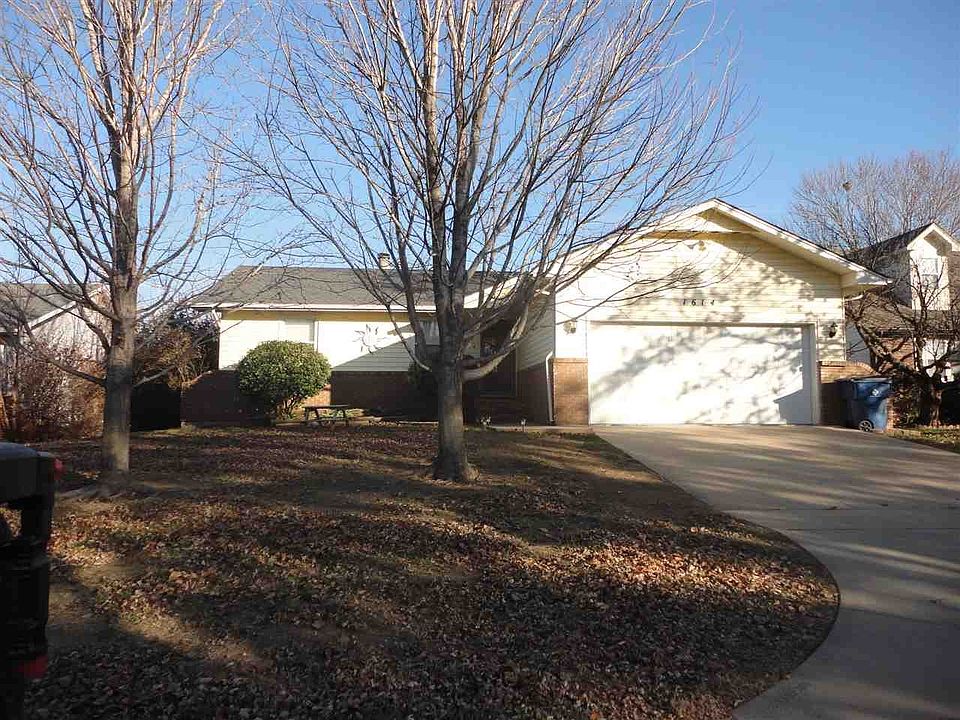 Front of house faces west. Mature trees in front yard and landscaping around front door and walkway