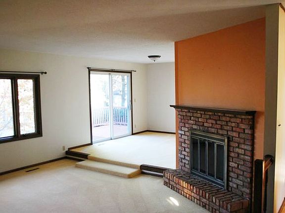 The two way wood burning fireplace will be cozy and warm on either side. This picture is from the living room toward the br /"dining room" showing the patio door to the 20' x 12' deck.