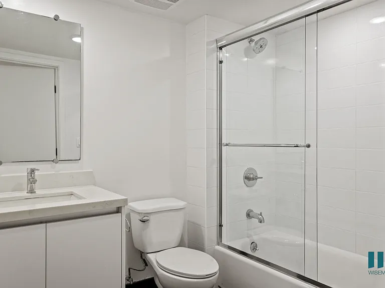 Bathroom with Shower Bath with Glass Door and Vanity Cabinet Storage