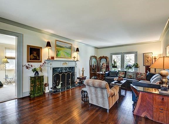 Living room with marble fireplace and Juliette balcony overlooking serene backyard!