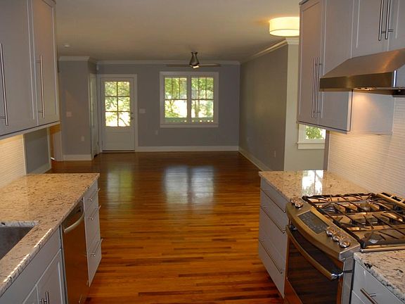 Living room with ceiling fan and hardwood floors throughout.