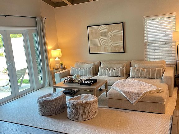 Large living room with fireplace and vaulted ceiling