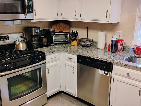 Kitchen with granite countertops, stainless steel appliances
