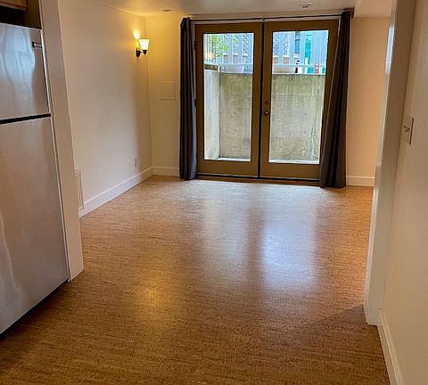 Enter apartment through large French Doors. Apartment flooring is bamboo.