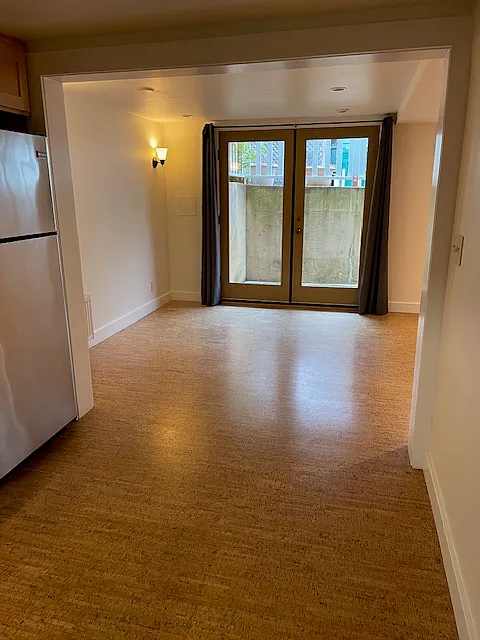 Enter apartment through large French Doors. Apartment flooring is bamboo.