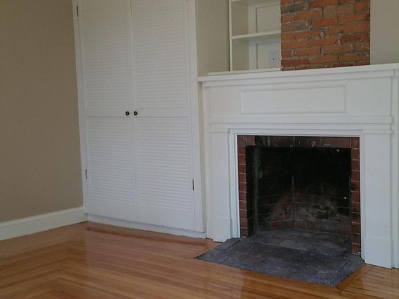 Master Bedroom with custom woodwork, fireplace, exposed bric