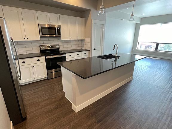 Large kitchen with massive island and bar seating. Plenty of cabinets and separate pantry. Full-sized stainless steel appliances