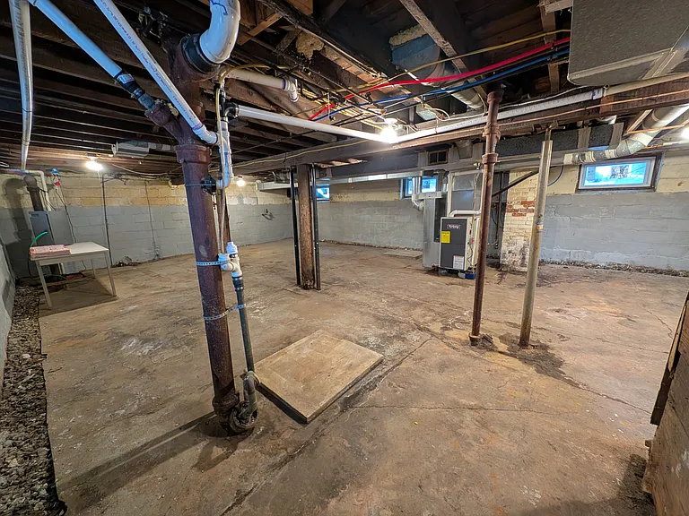 Full unfinished basement with lots of storage spage