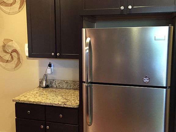 Stainless Refrigerator with space to put Groceries down before placing in Fridge.