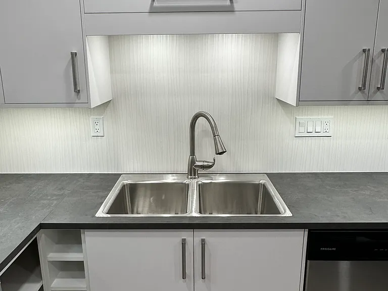 Functional new cabinets, under- counter lighting, wine rack, open shelves, new sink and faucet.