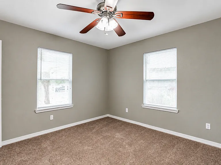 Jack & Jill Suite 2
A bright and spacious bedroom featuring large windows, abundant natural light, a ceiling fan, and direct access to the shared Jack & Jill bathroom