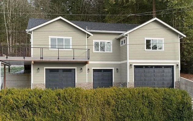 Front of home with spacious deck and use of one garage