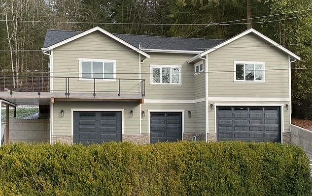 Front of home with spacious deck and use of one garage