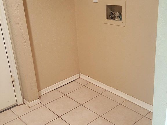 Utility room, off kitchen, door to garage