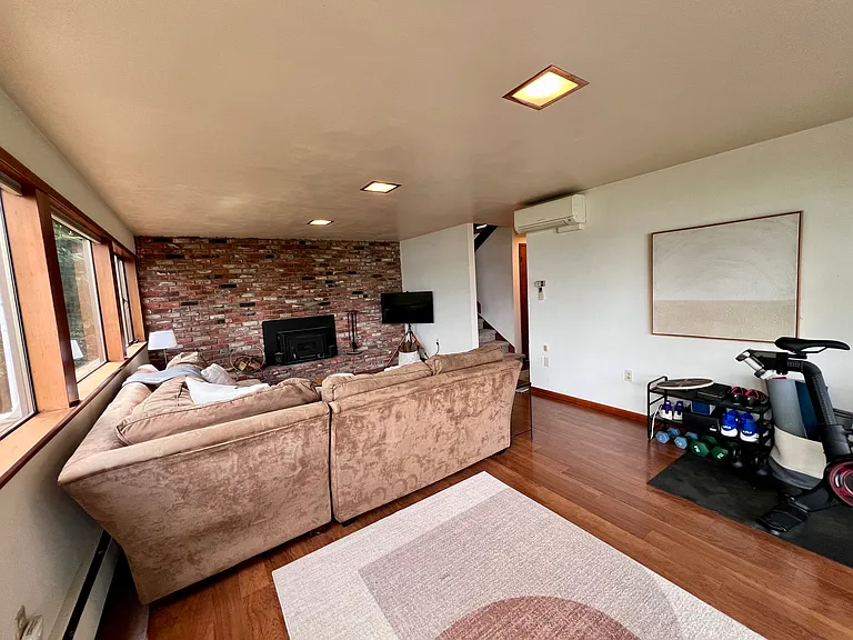 Another view of the lower-level family room with A/C. (The workout equipment will not stay with the rental.)