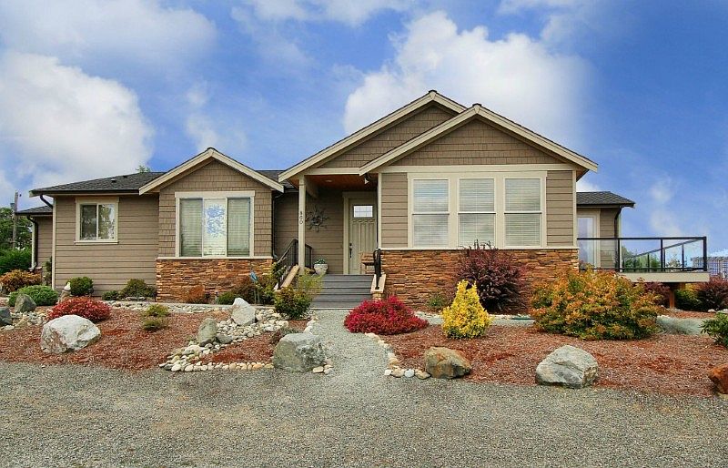 Elegant sprawling rambler in quality Rocky Point community with Sound and Mountain views. Composite decking, insulated 2 car garage, knotty pine soffits, cement plank siding with stone accents, concrete driveway.