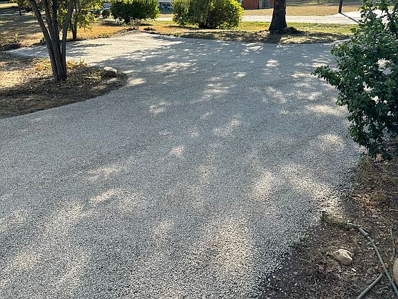 Freshly chip sealed driveway has two-car turnaround