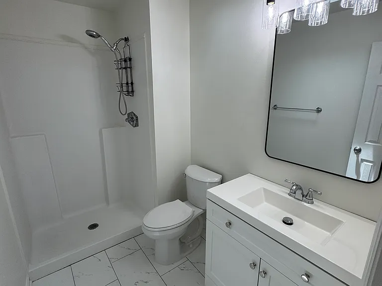 Primary bath with new vanity, mirror, light, toilet and floors!