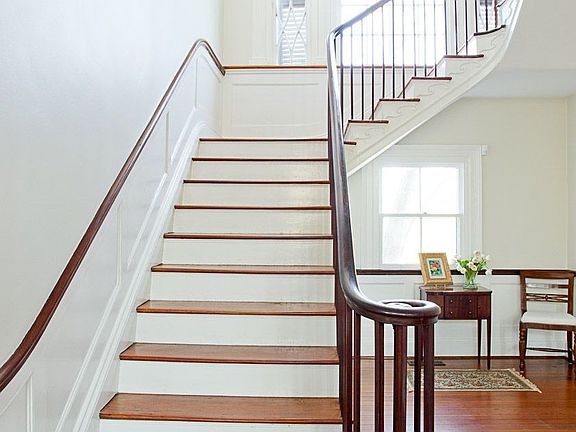 Grand entrance features an elegant mahogany cantilevered stairwell