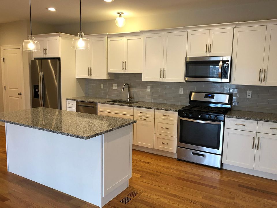 Kitchen includes stainless steel appliances, granite countertops, island and pantry closet. Ample cabinets for storage. Open concept floor plan on main level.