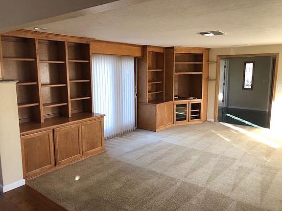 Living room Built in bookcases and slider out to patio.