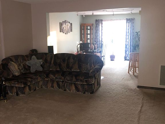 Living room and dining area, light coming through the balcony