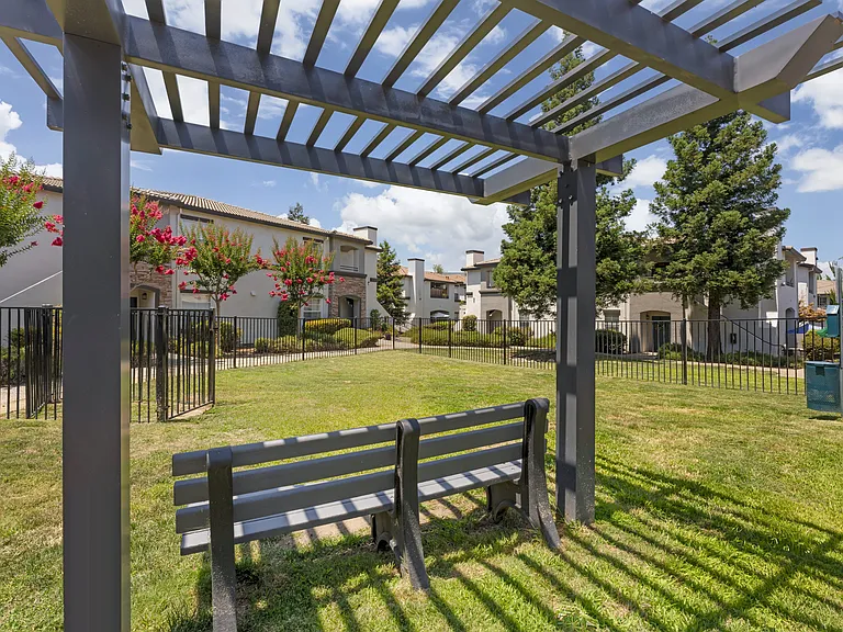 Our gated dog park features a semi-shaded gazebo and comfortable seating, creating a relaxing space for pet owners while their dogs play and socialize at Ascent at the Galleria.