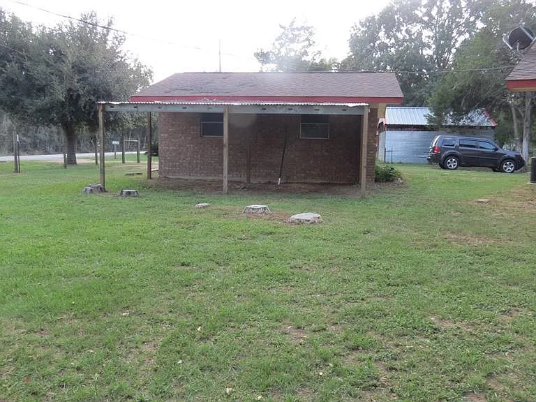 behind the 2 car Garage for additional covered parking
