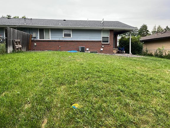 Large, fenced-in backyard includes sprinkler system.