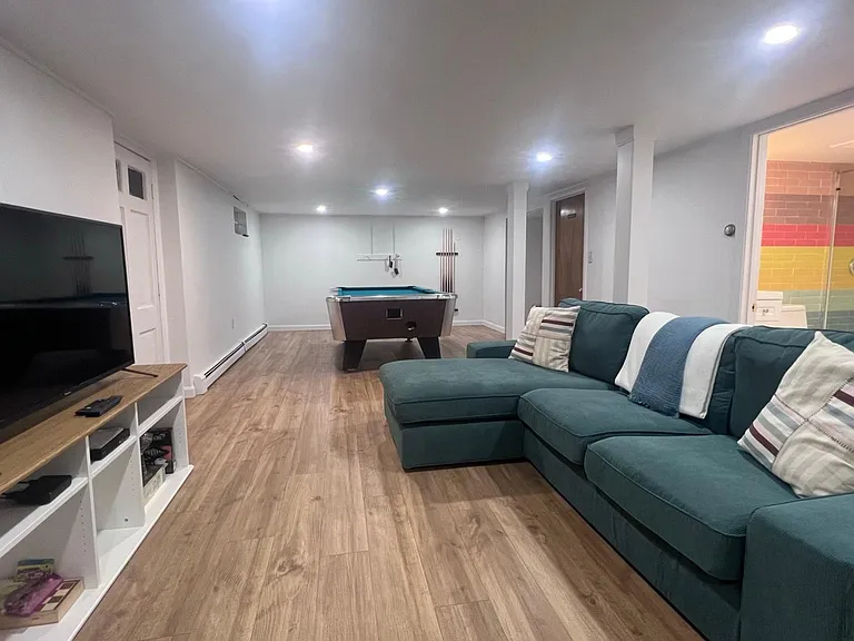looking from the dinette towards the pool table and and full bath on the right