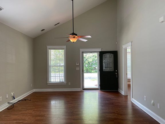 Nice vaulted ceiling and natural light in living room.