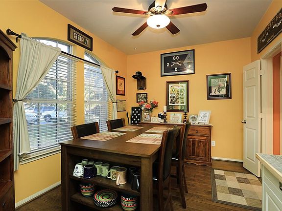 Formal dining opens to entryway with french doors leading to kitchen area.