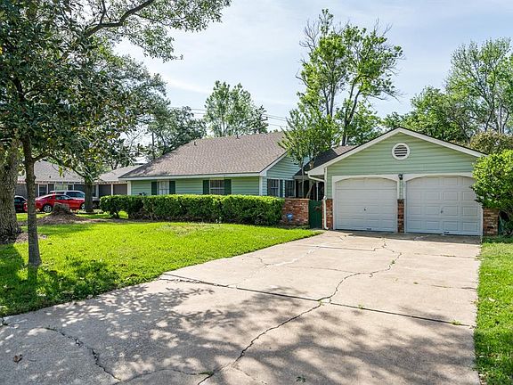 This property has a double wide driveway as well as mature trees and landscaping.