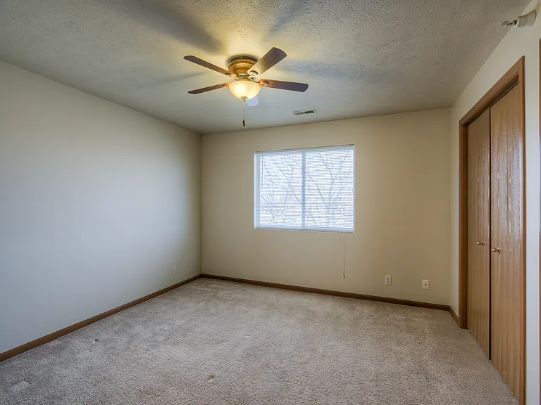 Bedroom with high ceilings at Huntington Apartments.