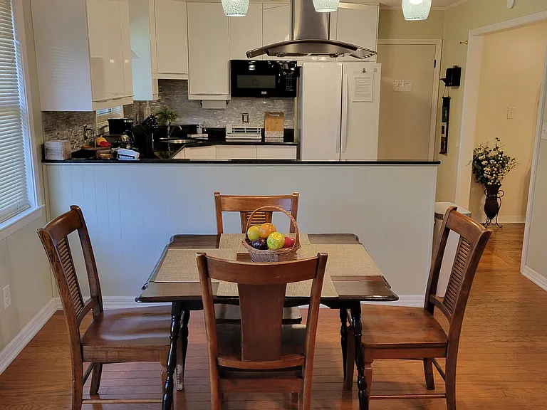 The nook, with small table and chairs, separates the family room and the kitchen.