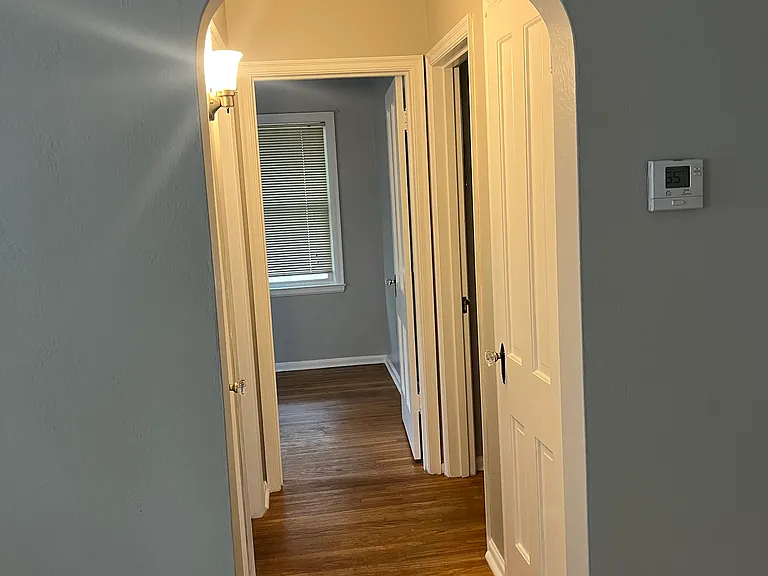 hallway leading to bedrooms and bathroom