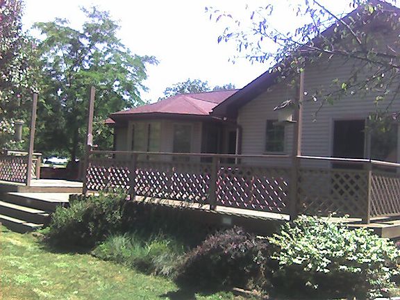Full length two tier deck behind the house with access from MBR and Family Room.