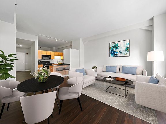 Open concept living with hardwood floors, high ceilings, and tons of natural light (staged)