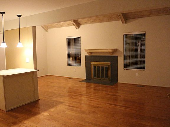 Beautiful hardwood floors and vaulted wood ceiling in family space