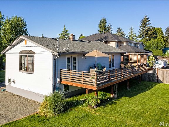 Deck runs the full length of the house.  French doors to the far right is off the Master Bedroom.  Doors on the far left off the Living Room. 