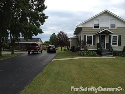 Front view of Home
						:
						Partial view of Black Topped Circular Driveway